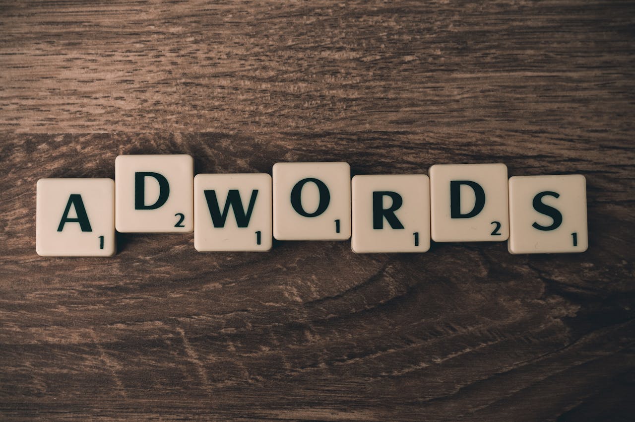home-hero Scrabble tiles spelling 'AdWords' on a wooden surface, symbolizing digital marketing concepts.